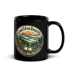 Gatlinburg and the Smokies Black Coffee Mug: Gatlinburg. Less Hurry, More Mountain, Vintage Round Badge - 11 oz - Handle on Right