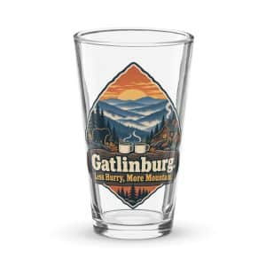 Gatlinburg and the Smokies Pint Glass: Gatlinburg. Less Hurry, More Mountain, Scenic Shield Badge - 16 oz - Main
