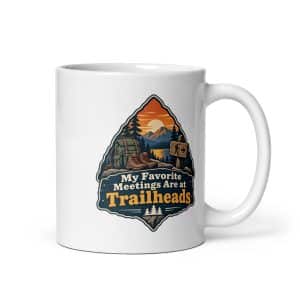 Nature and Adventure White Ceramic Coffee Mug: My Favorite Meetings Are at Trailheads, Scenic Shield Badge - 11 oz - Main